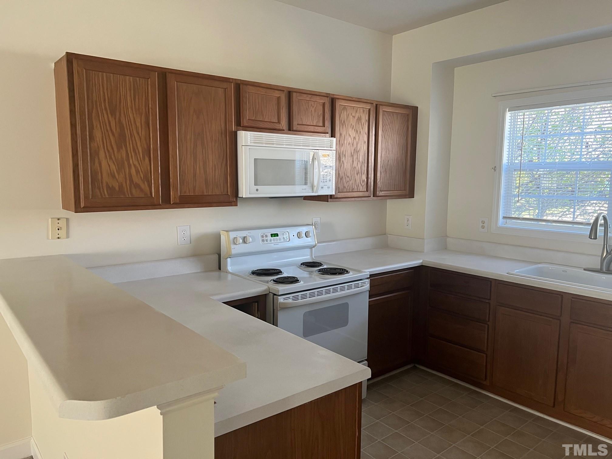 4644 Centrebrook Circle Raleigh, NC 27616 - Photo 3 of 11 a kitchen with stainless steel appliances granite countertop a sink stove and microwave