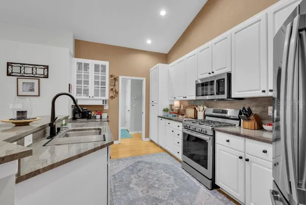a living room with furniture and view of kitchen