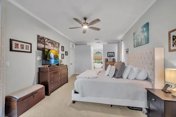 a bedroom with a bed and a chandelier