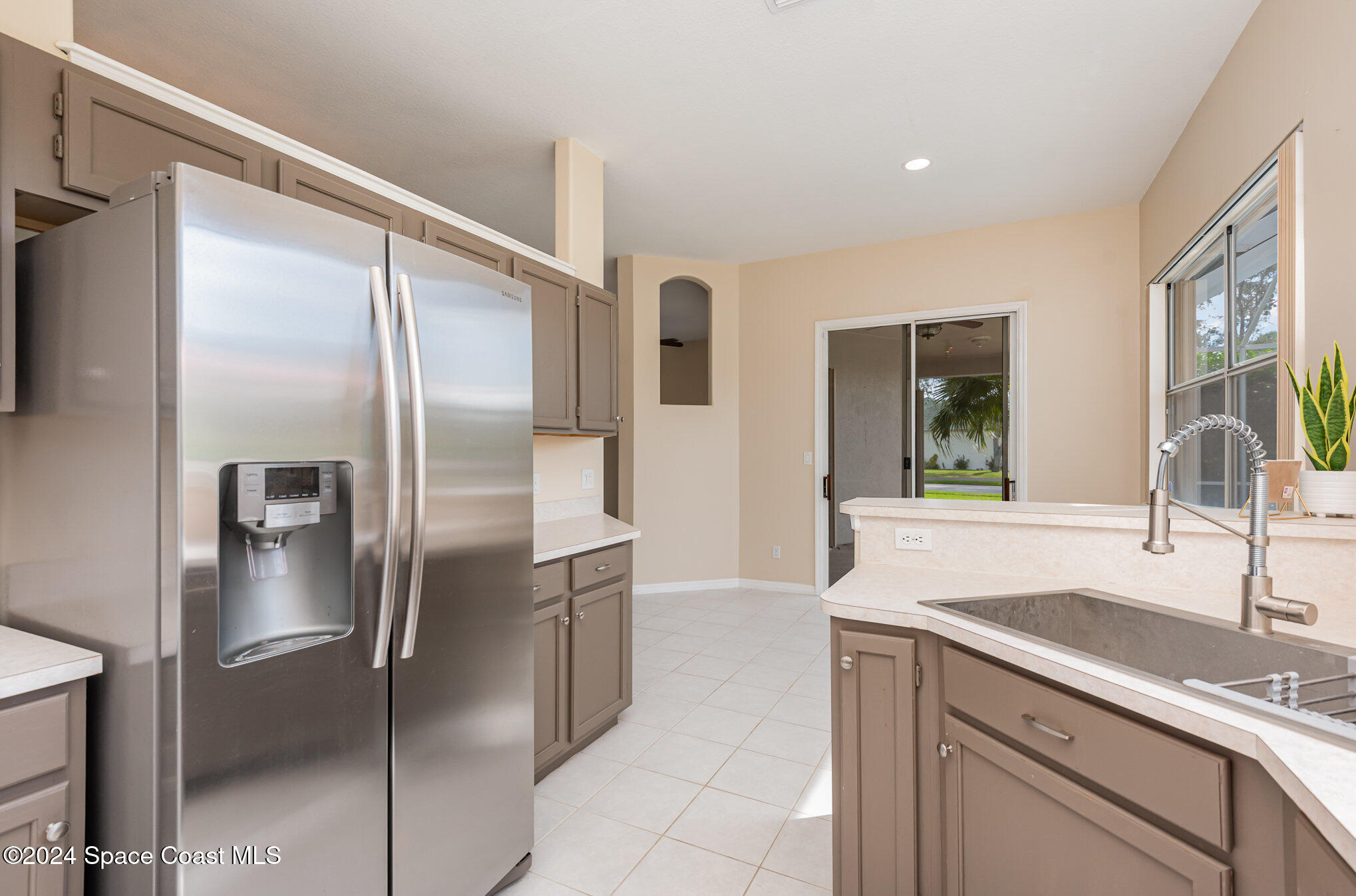 779 Thrasher Drive Rockledge, FL 32955 - Photo 11 of 35 a kitchen with stainless steel appliances granite countertop a refrigerator and a sink