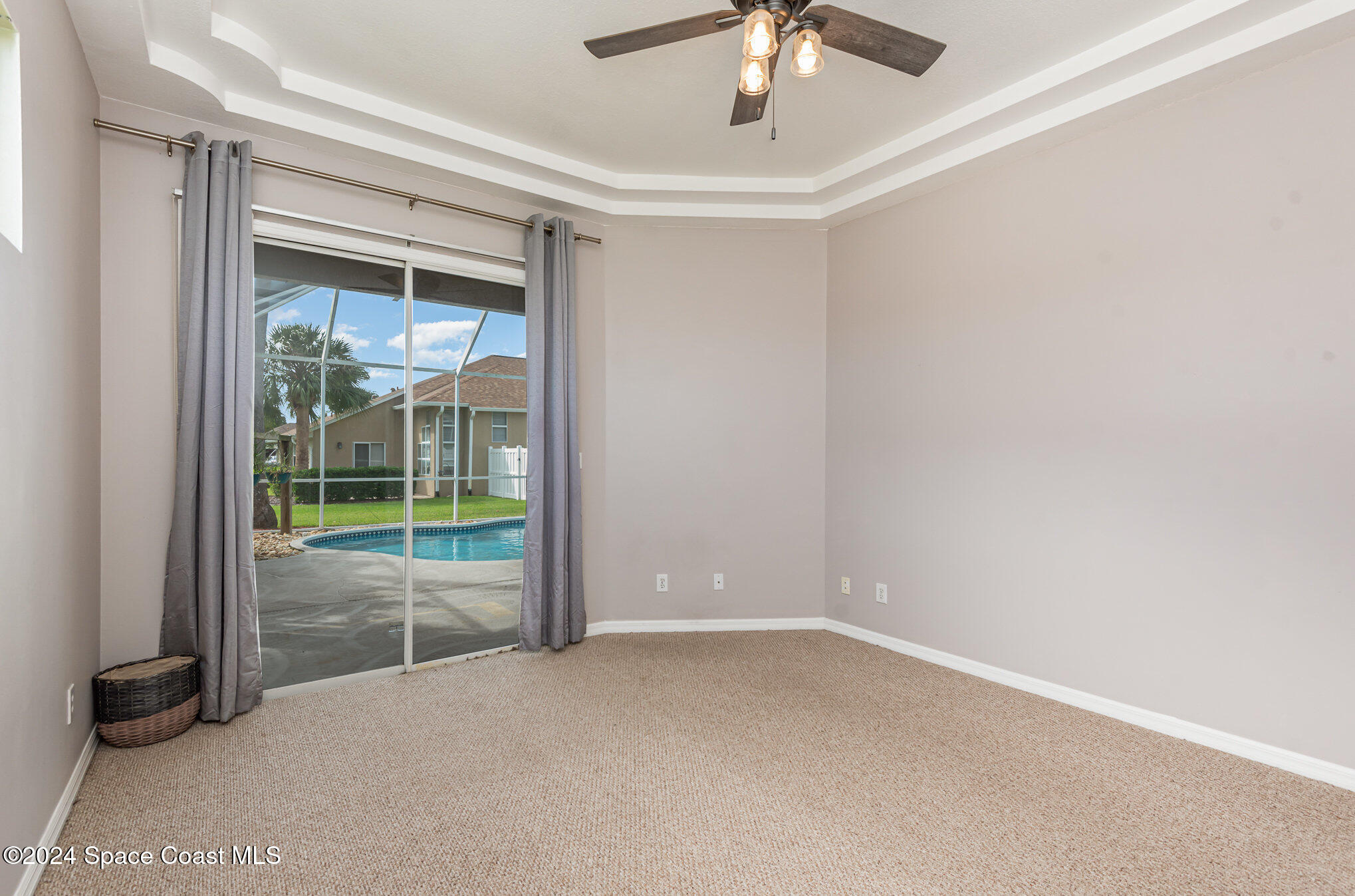 779 Thrasher Drive Rockledge, FL 32955 - Photo 16 of 35 an empty room with windows and ceiling fan