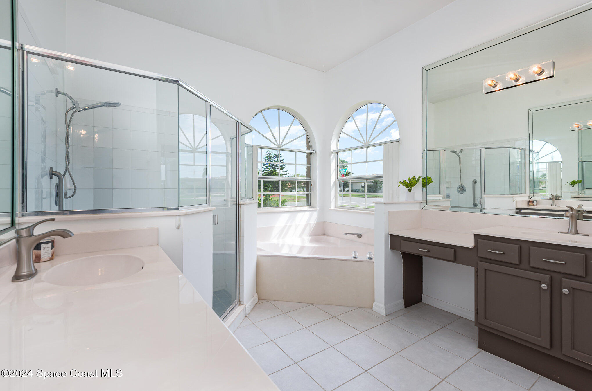 779 Thrasher Drive Rockledge, FL 32955 - Photo 18 of 35 a spacious bathroom with a sink mirror and a bathtub in it