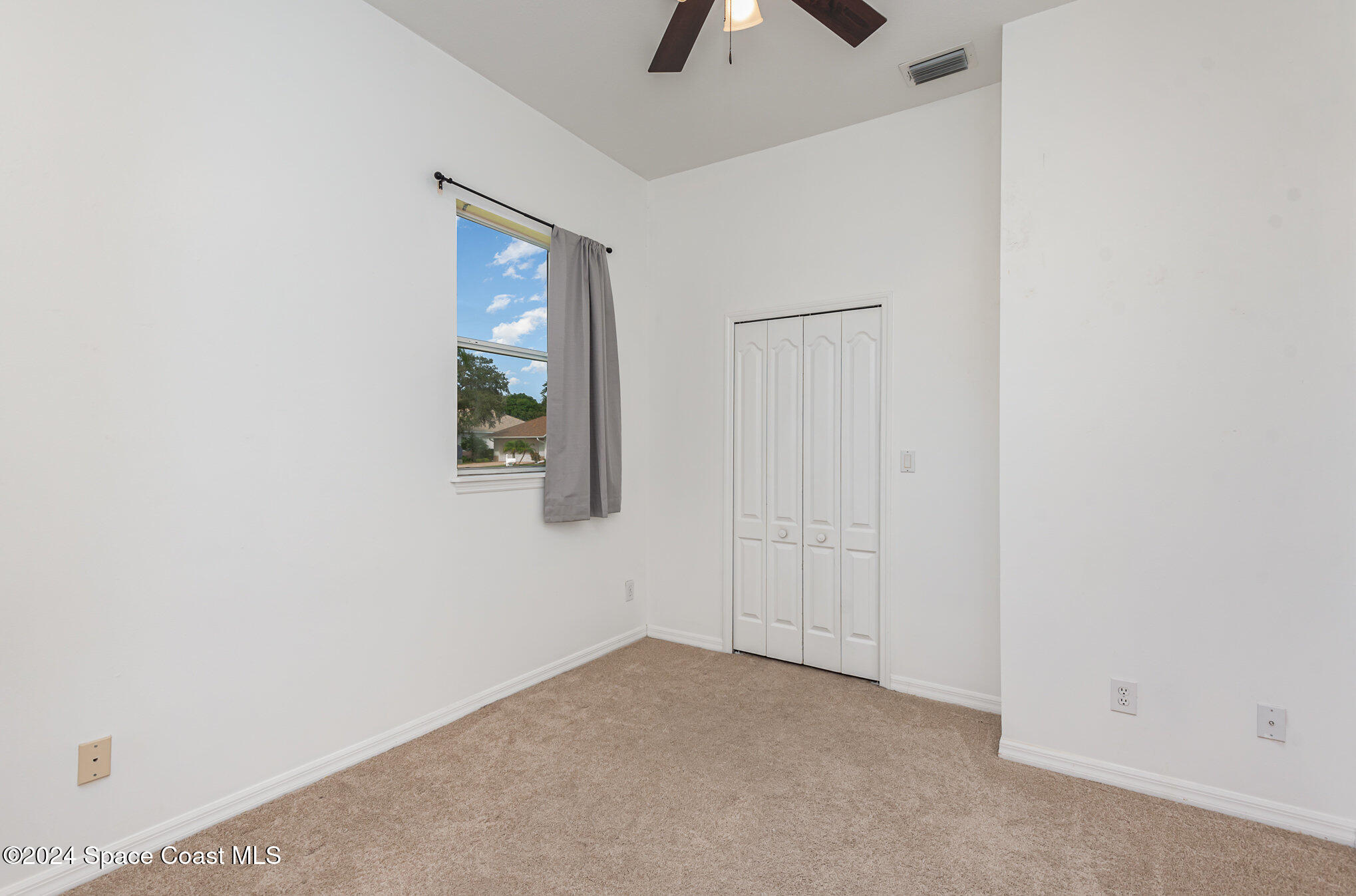 779 Thrasher Drive Rockledge, FL 32955 - Photo 22 of 35 an empty room with windows and cabinet