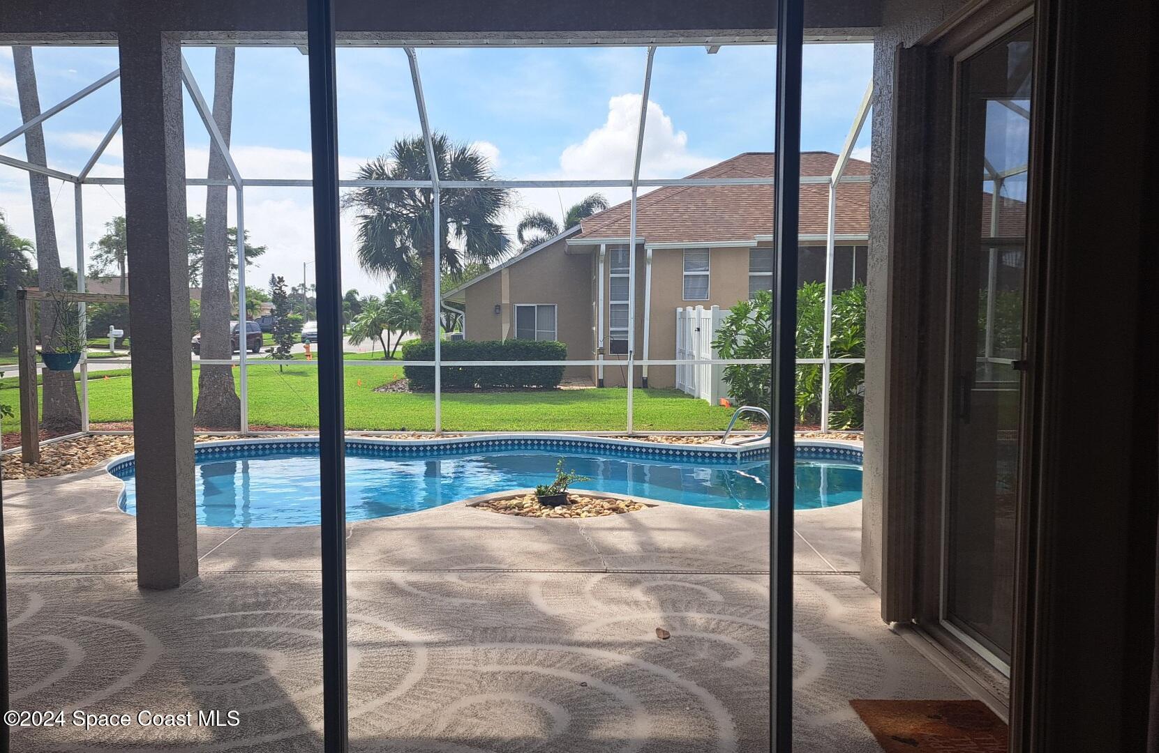779 Thrasher Drive Rockledge, FL 32955 - Photo 27 of 35 a view of swimming pool with a yard and sitting area