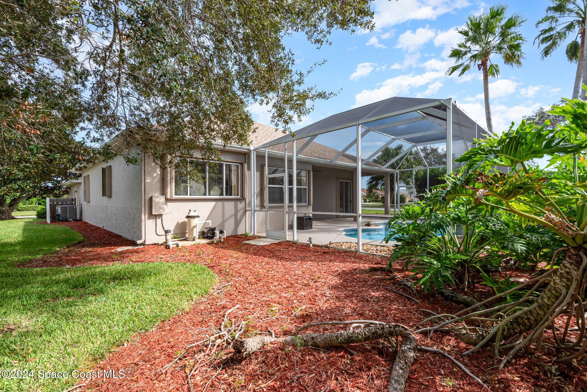 779 Thrasher Drive Rockledge, FL 32955 - Photo 31 of 35 a front view of a house with a garden and yard