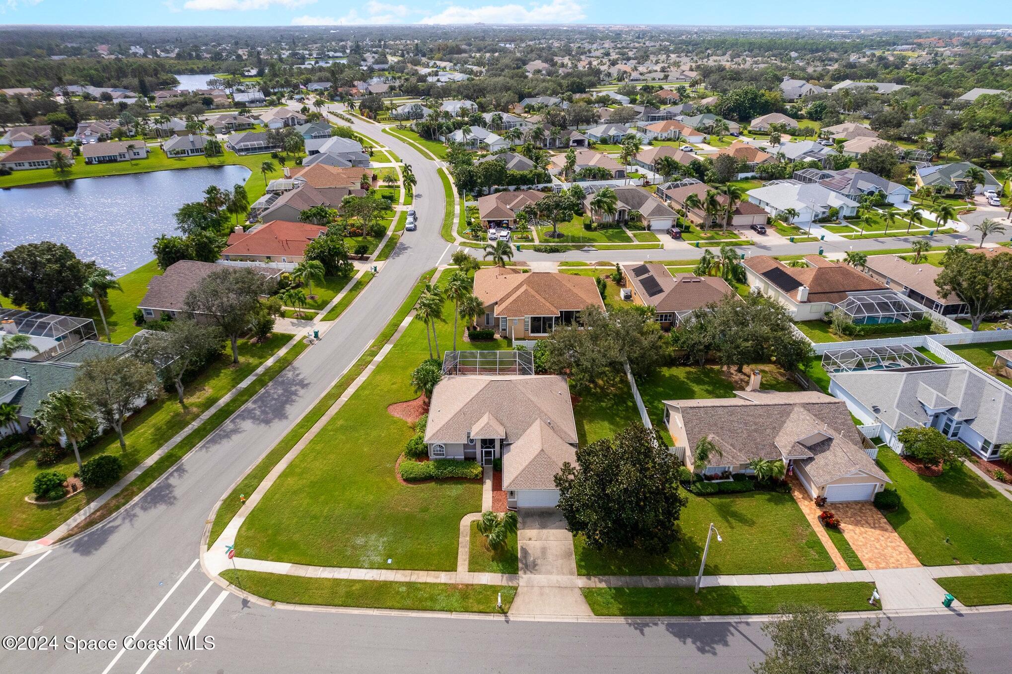 779 Thrasher Drive Rockledge, FL 32955 - Photo 33 of 35 an aerial view of a house with a swimming pool yard and mountain view in back