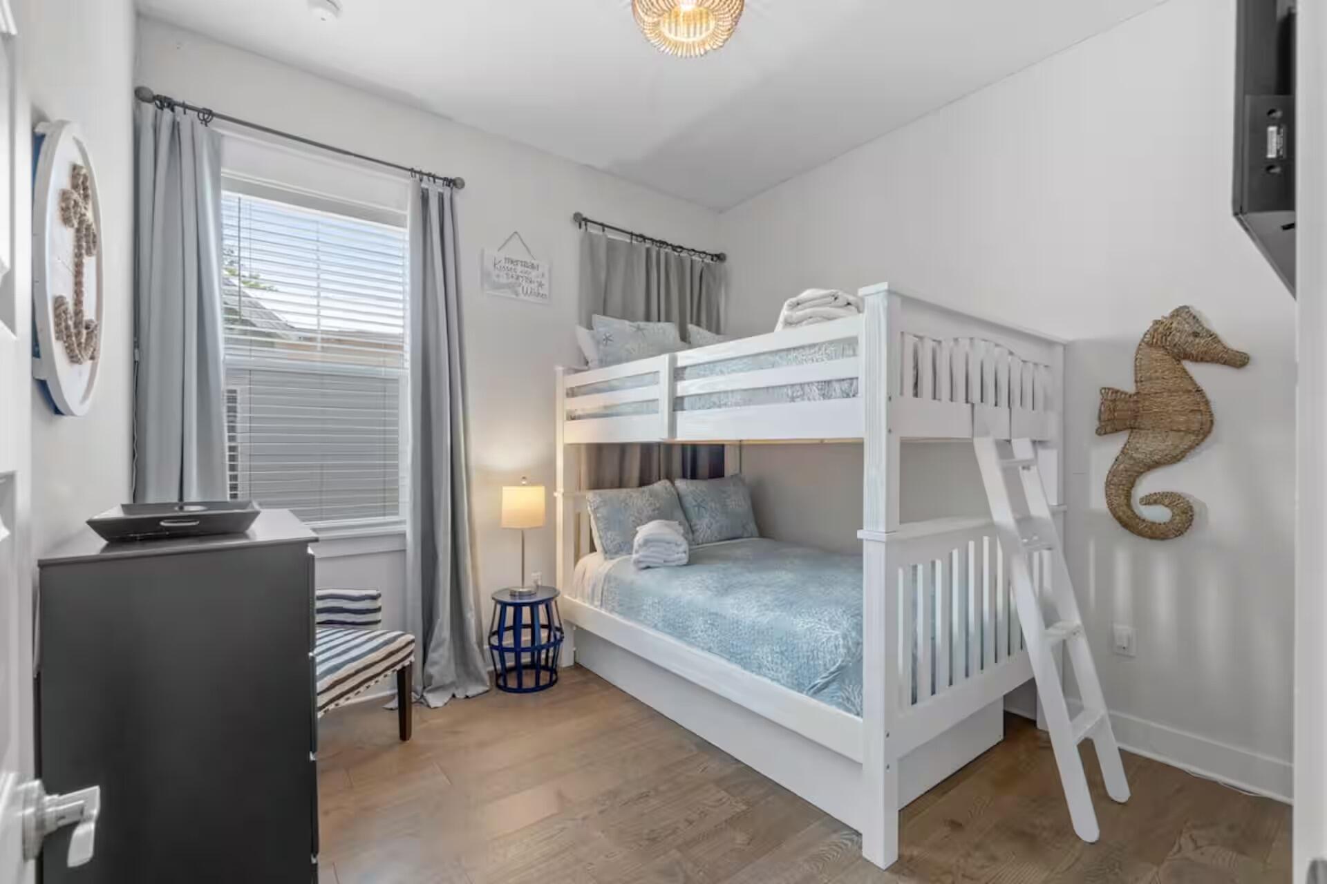 146 East E Pine, Unit B Inlet Beach, FL 32461 - Photo 23 of 47 a bedroom with a bed and dresser with windows