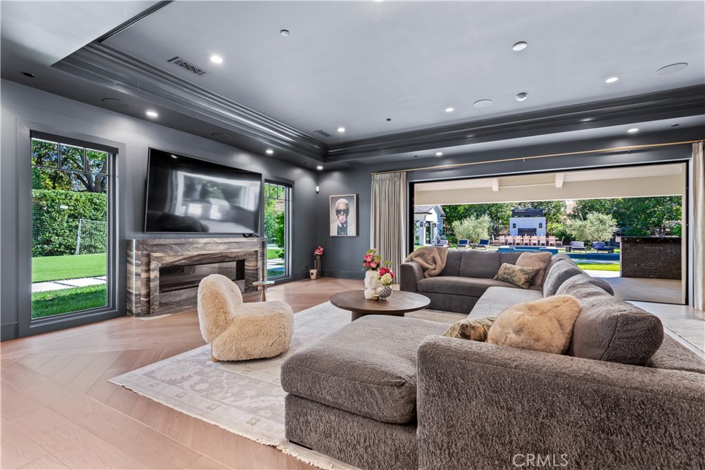 23924 Long Valley Road Hidden Hills, CA 91302 - Photo 11 of 39 a living room with furniture fireplace and a large window