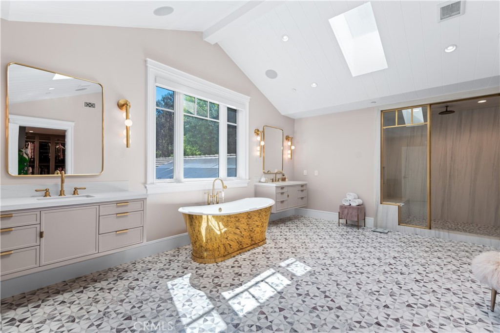 23924 Long Valley Road Hidden Hills, CA 91302 - Photo 21 of 39 a spacious bathroom with a tub sink and mirror