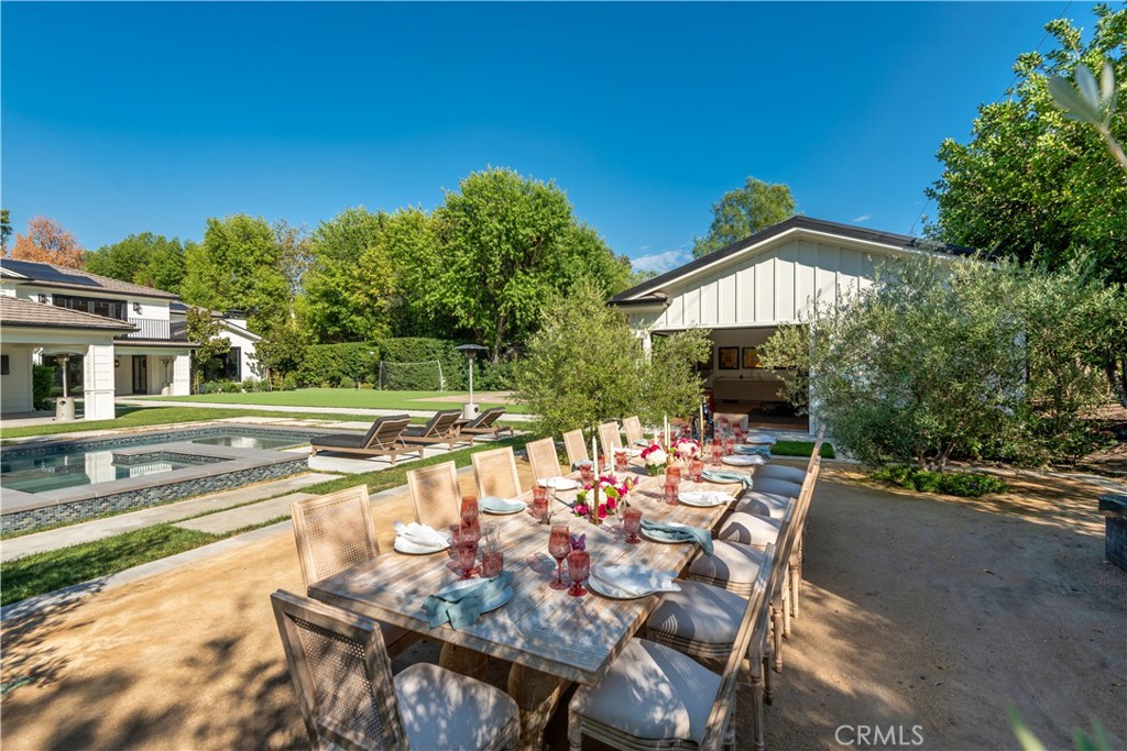 23924 Long Valley Road Hidden Hills, CA 91302 - Photo 28 of 39 a view of a patio with table and chairs and potted plants with wooden floor and fence