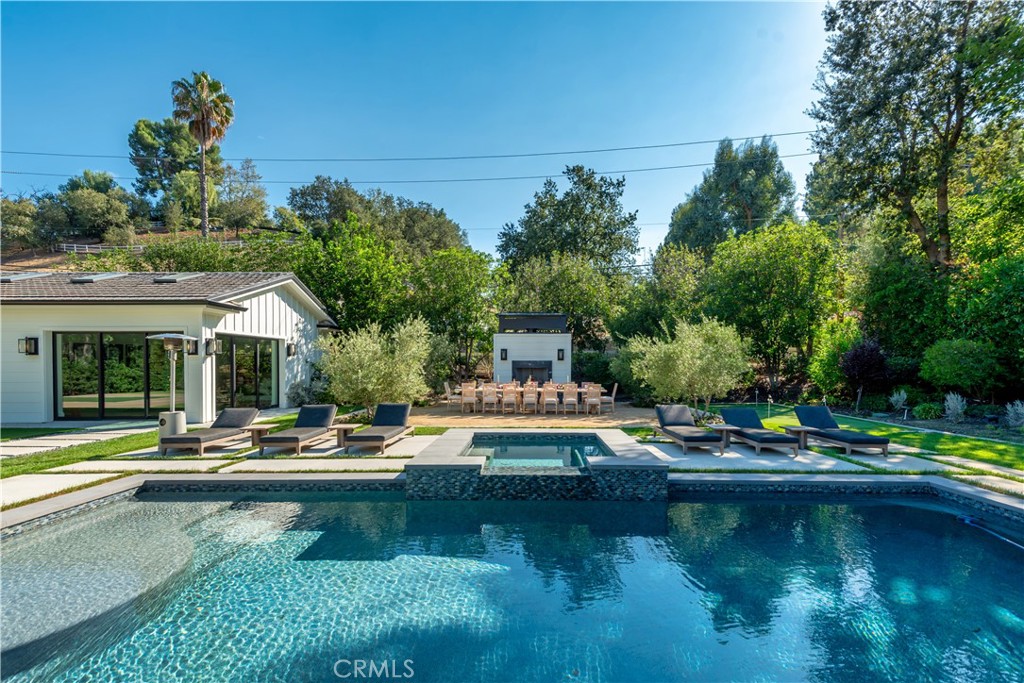 23924 Long Valley Road Hidden Hills, CA 91302 - Photo 29 of 39 a view of a house with swimming pool and sitting area