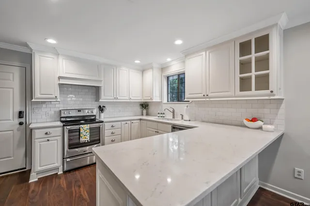 a kitchen with a stove a sink and a refrigerator
