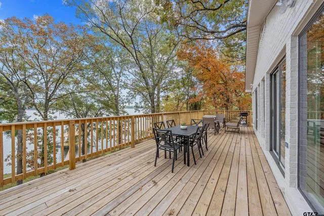 a view of backyard with a deck and wooden floor