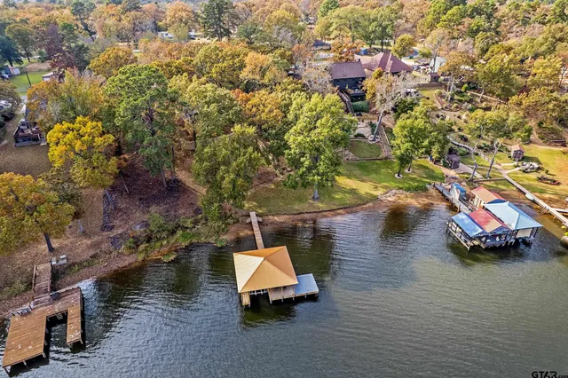 an aerial view of a house with a yard