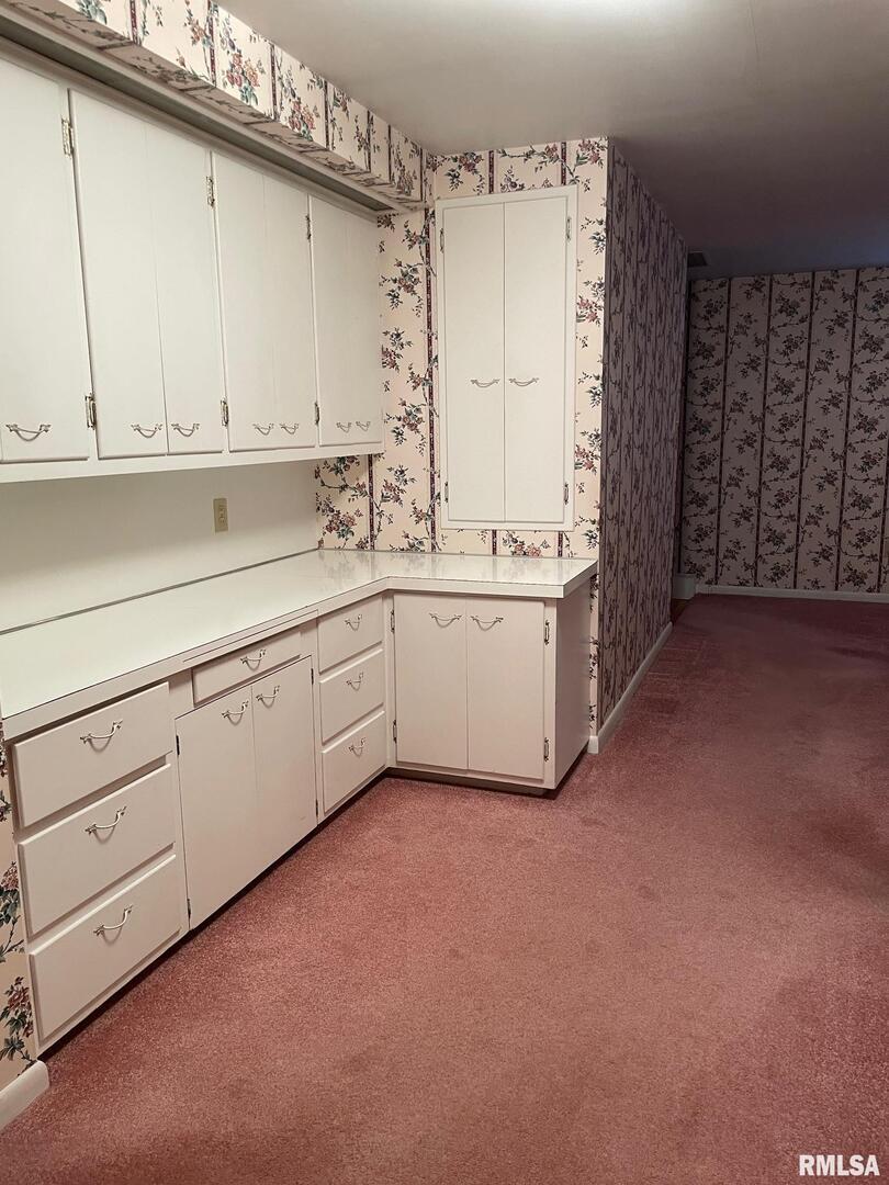 901 Elm Street Carmi, IL 62821 - Photo 14 of 21 a kitchen with white cabinets and sink