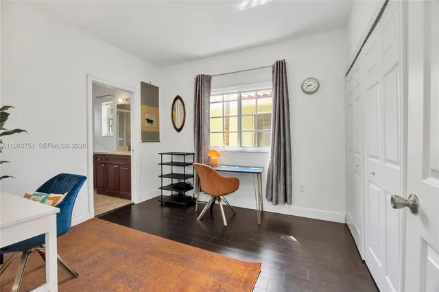 a bathroom with a granite countertop sink a mirror and a shower