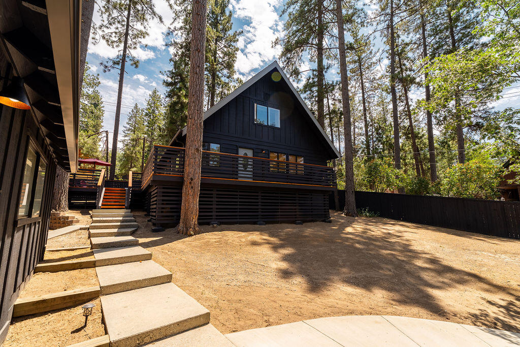 53589 Tollgate Road Idyllwild, CA 92549 - Photo 12 of 51 a view of wooden house with a large window and wooden fence
