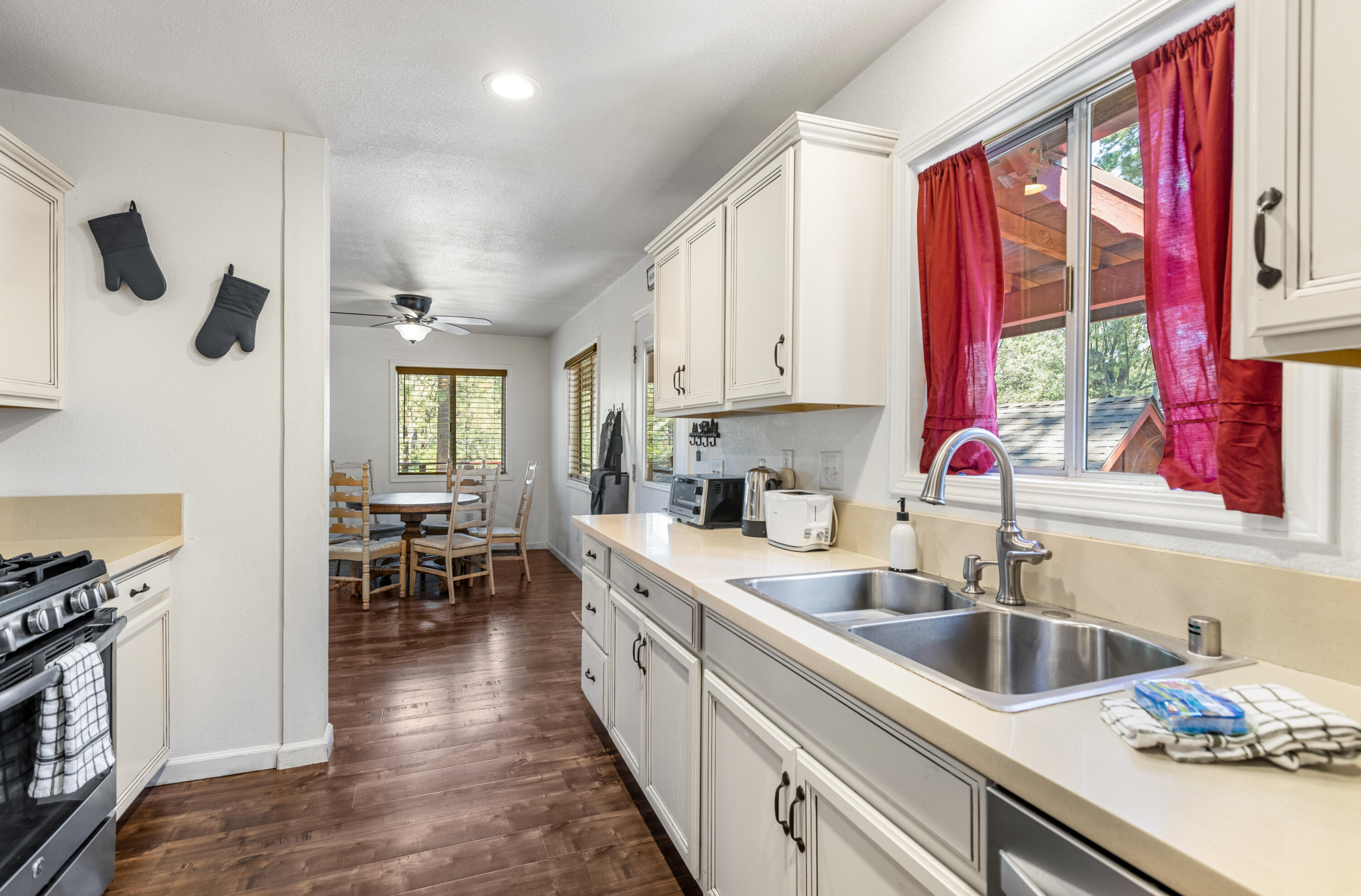 53589 Tollgate Road Idyllwild, CA 92549 - Photo 23 of 51 a kitchen with a sink stove and cabinets