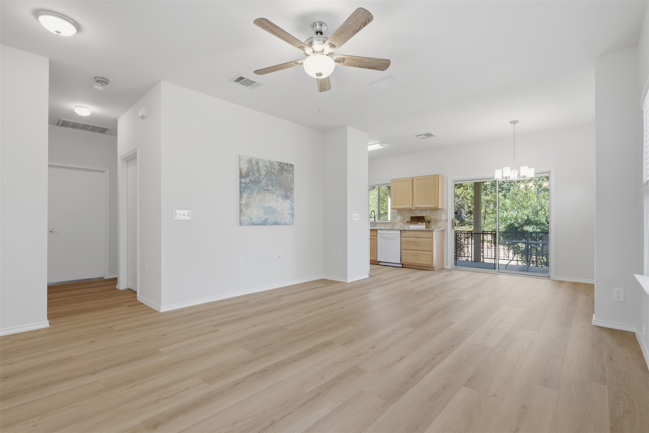 126 Whitewing Way Georgetown, TX 78633 - Photo 11 of 28 Luminous open-concept living space with sleek flooring and balcony access for effortless entertaining.