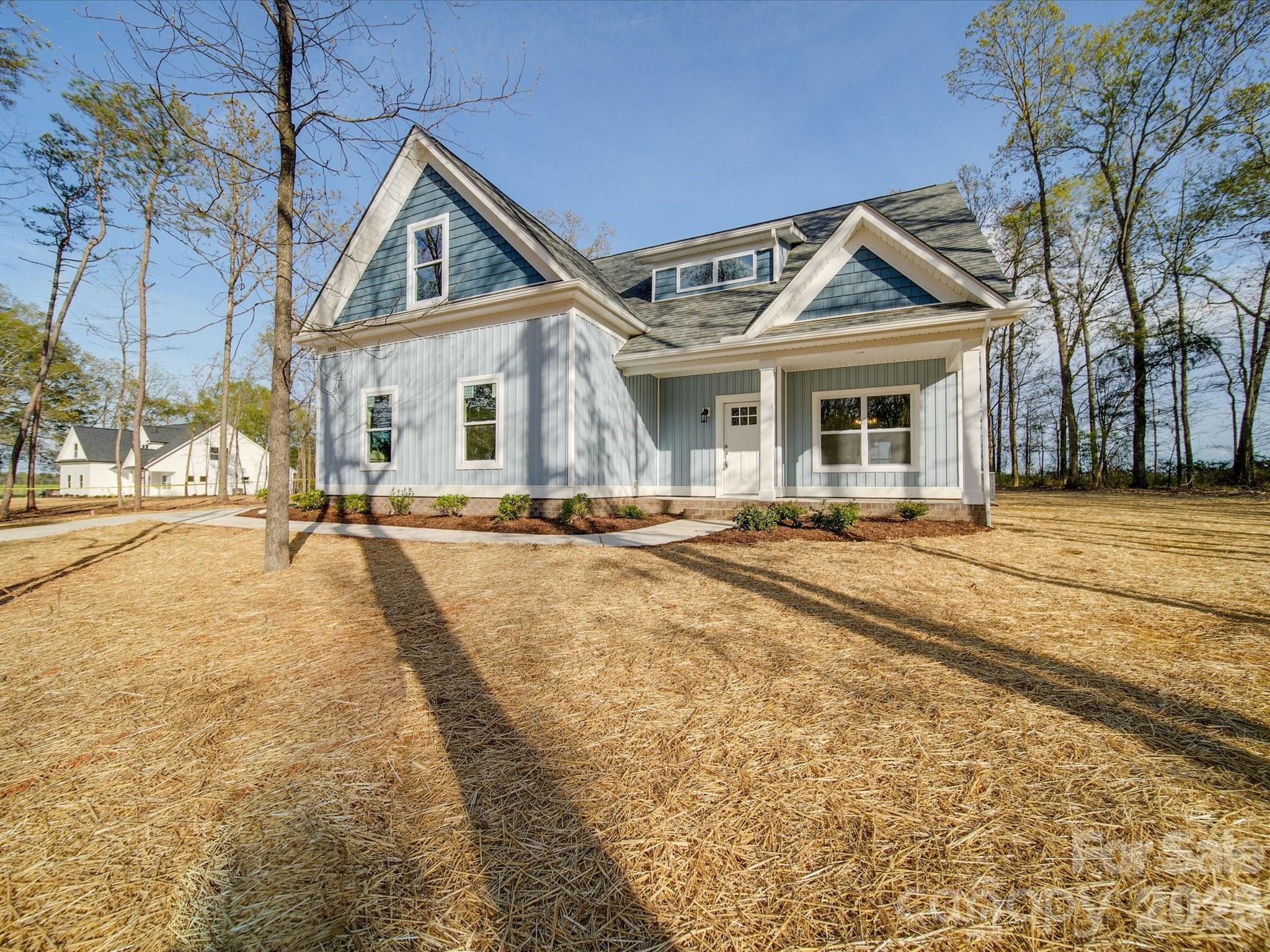 0 Hinson Road Monroe, NC 28112 - Photo 1 of 12 a view of a white house with a large trees next to a yard