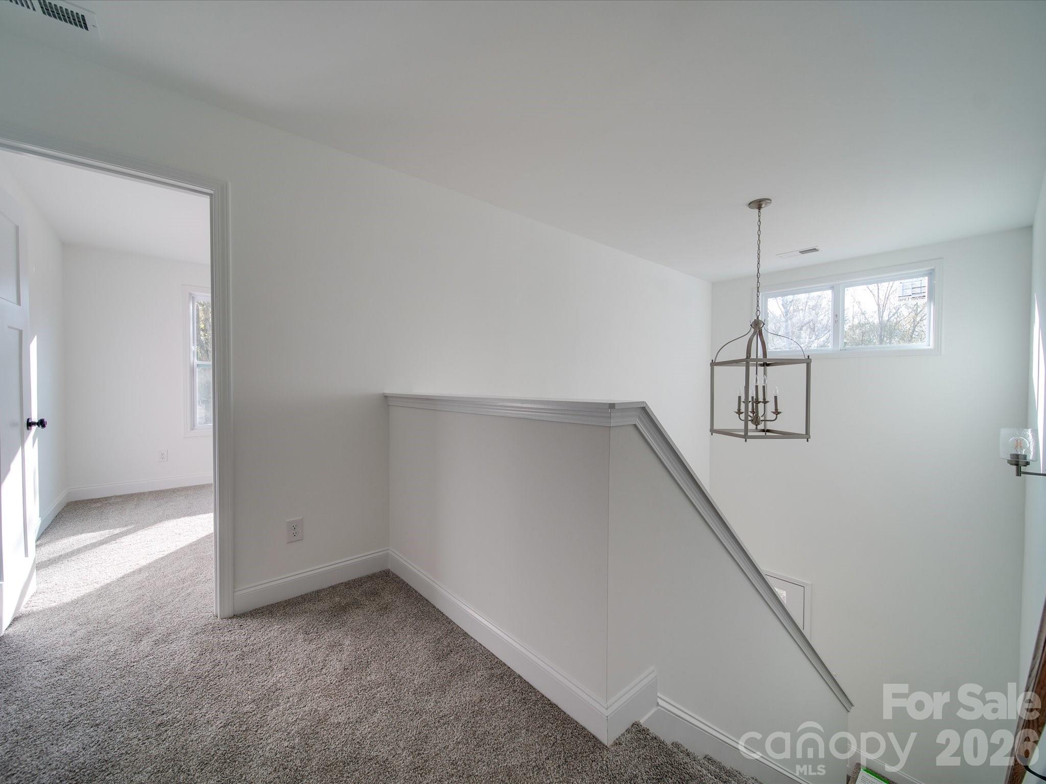 0 Hinson Road Monroe, NC 28112 - Photo 9 of 12 an empty room with windows and ceiling fan