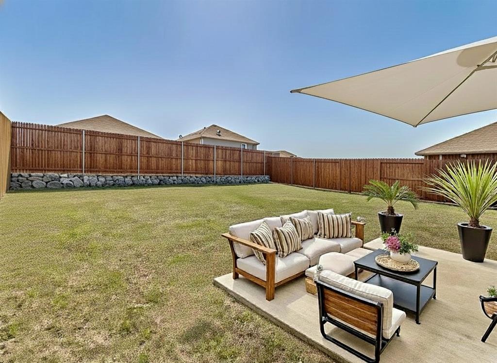 801 Peach Tree Lane Anna, TX 75409 - Photo 2 of 14 a balcony with furniture and a potted plant