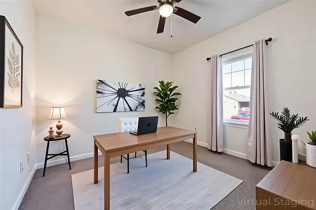 a view of a livingroom with furniture a potted plant and wooden floor