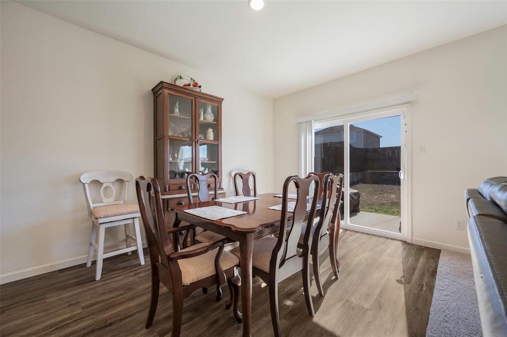 801 Peach Tree Lane Anna, TX 75409 - Photo 7 of 14 a view of a dining room with furniture and wooden floor