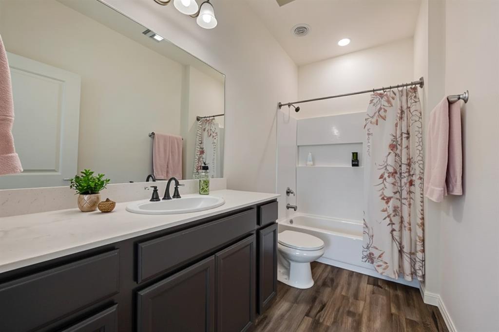 801 Peach Tree Lane Anna, TX 75409 - Photo 9 of 14 a bathroom with a sink a toilet a shower and a mirror