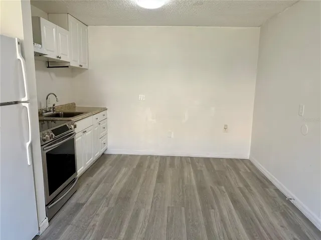 a kitchen with cabinets and steel stainless steel appliances