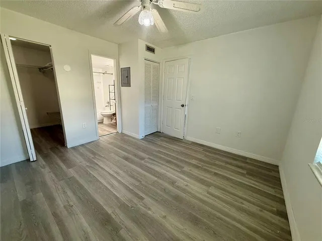 a view of empty room with wooden floor
