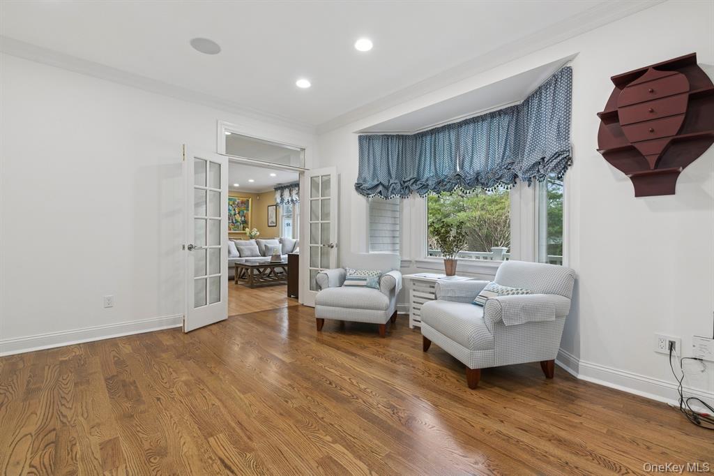 15 Carter Road Hampton Bays, NY 11946 - Photo 18 of 47 Living area featuring french doors, wood finished floors, ornamental molding, recessed lighting, and healthy amount of natural light