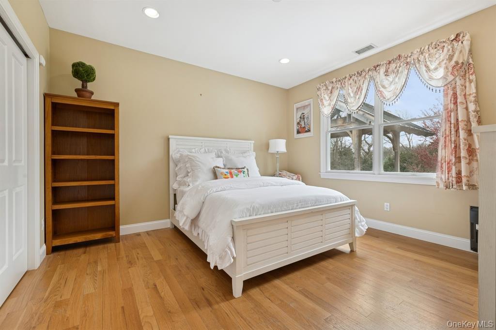 15 Carter Road Hampton Bays, NY 11946 - Photo 22 of 47 Bedroom featuring light wood finished floors, recessed lighting, and a closet