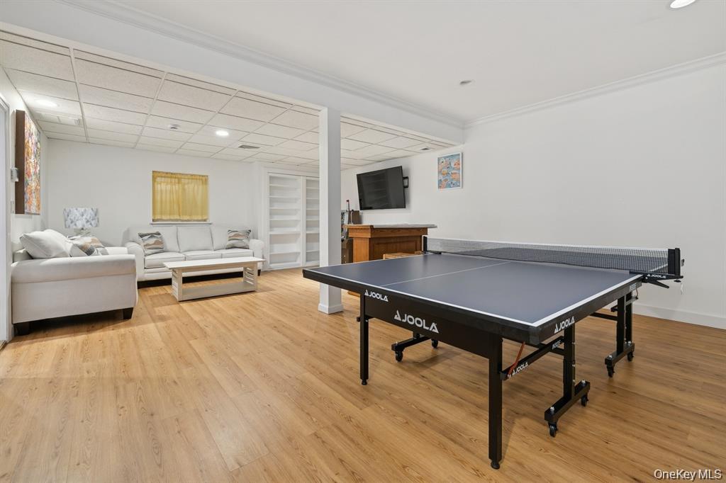 15 Carter Road Hampton Bays, NY 11946 - Photo 33 of 47 Game room with light wood finished floors, recessed lighting, a drop ceiling, and crown molding