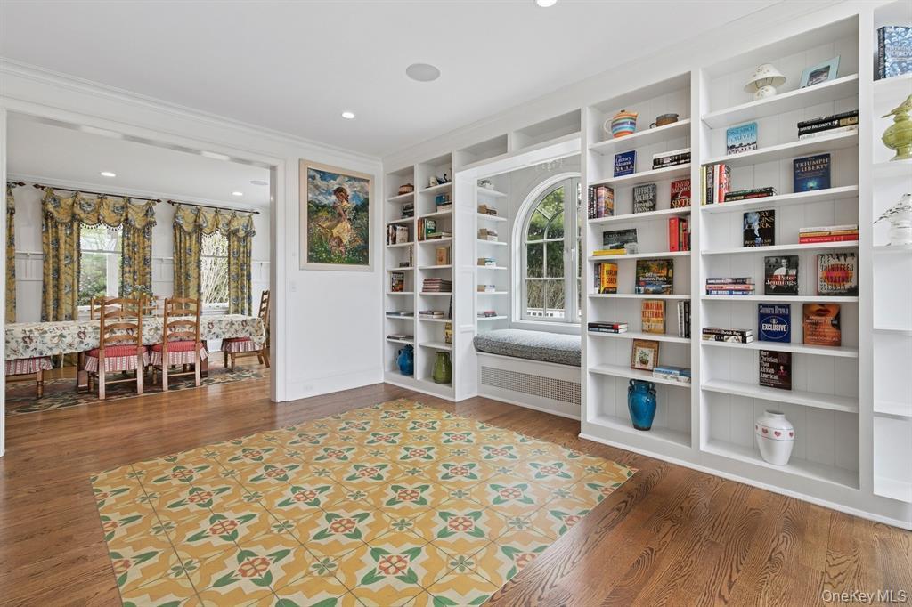 15 Carter Road Hampton Bays, NY 11946 - Photo 10 of 47 Sitting room with plenty of natural light, built in features, wood finished floors, and crown molding