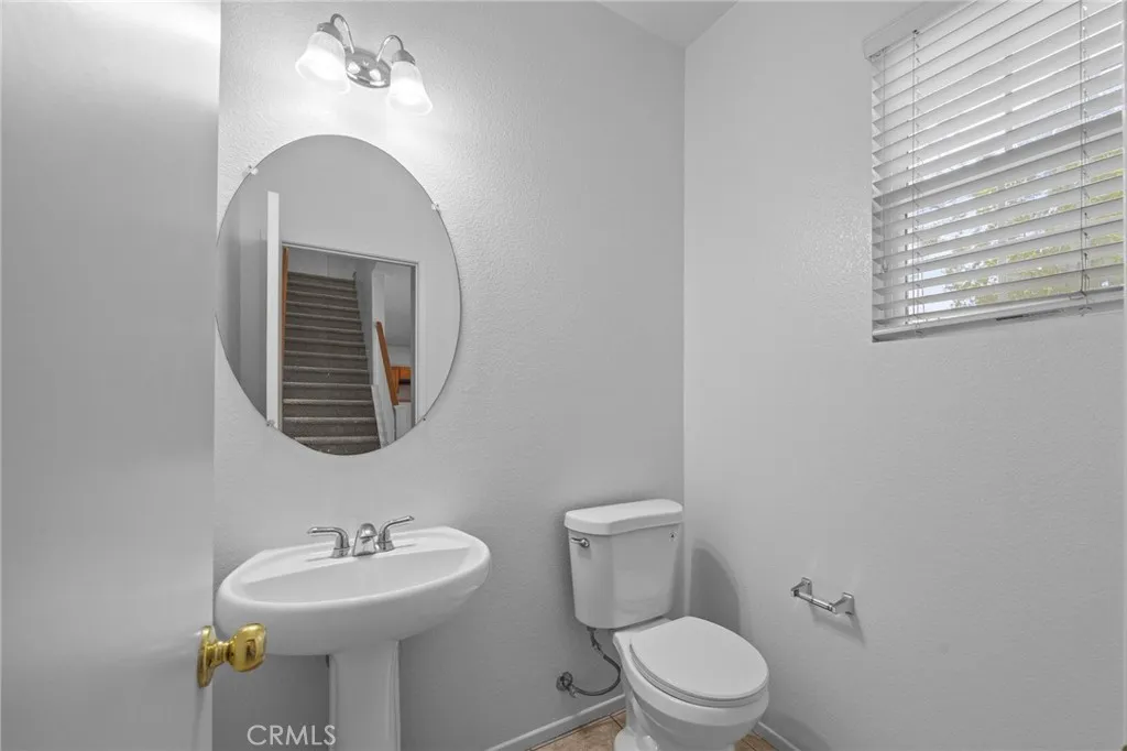 7353 Ellena West Street West, Unit 112 Rancho Cucamonga, CA 91730 - Photo 16 of 38 a bathroom with a toilet sink and mirror