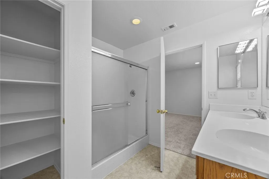 7353 Ellena West Street West, Unit 112 Rancho Cucamonga, CA 91730 - Photo 23 of 38 a bathroom with a sink and shower