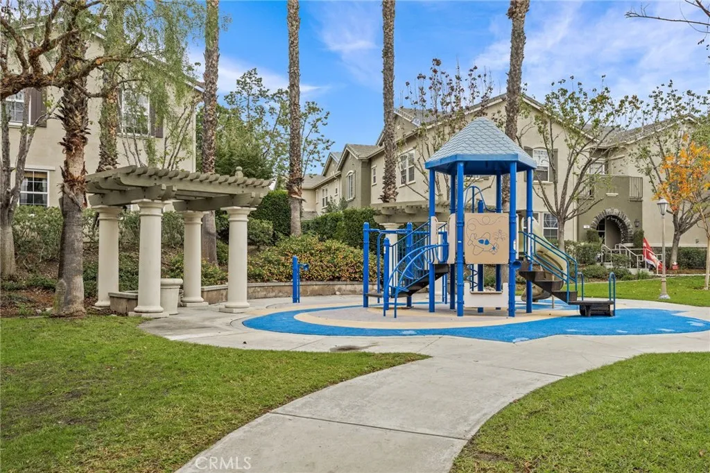 7353 Ellena West Street West, Unit 112 Rancho Cucamonga, CA 91730 - Photo 34 of 38 a front view of a building with garden and trees