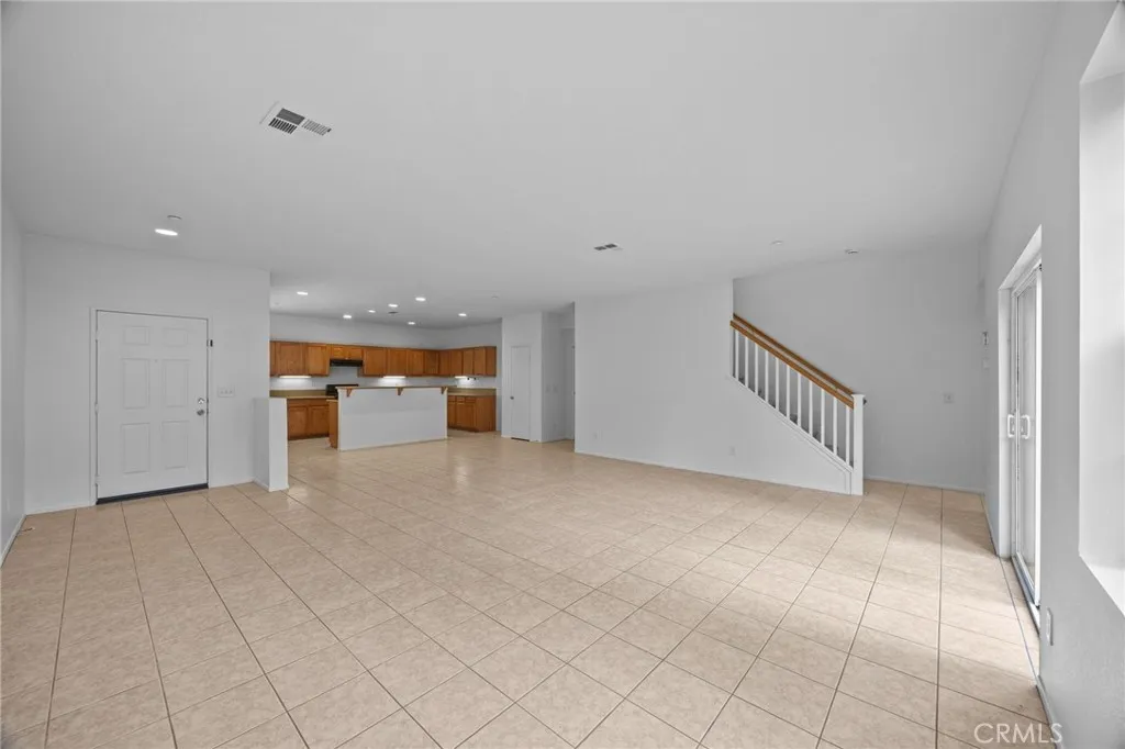 7353 Ellena West Street West, Unit 112 Rancho Cucamonga, CA 91730 - Photo 7 of 38 a view of an empty room and a kitchen