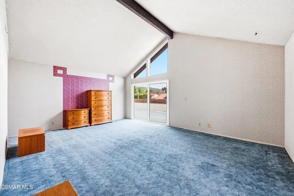 an empty room with wooden floor and potted plant