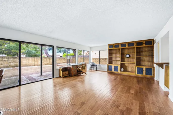 a living room with furniture and floor to ceiling windows