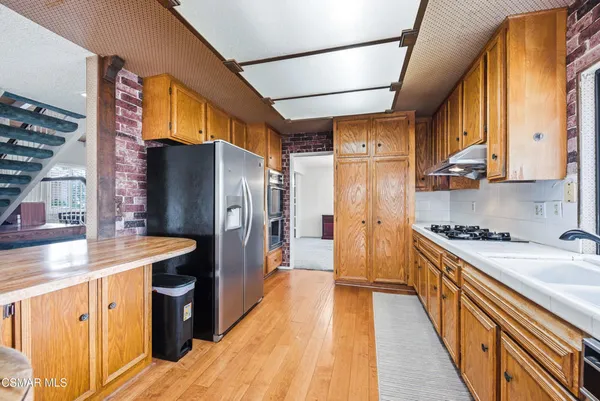 a kitchen with lots of counter top space and wooden floor
