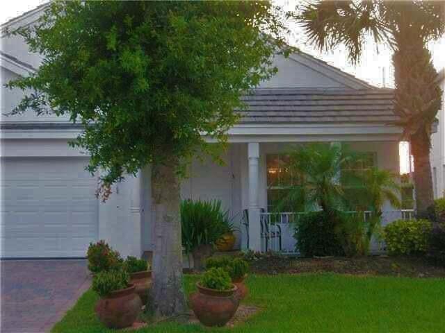 a house that has a tree in front of it