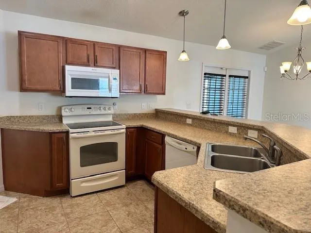 a kitchen with a sink stove and microwave