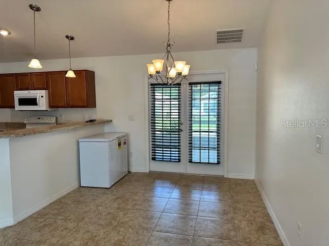 a view of a kitchen with a sink and dishwasher cabinet