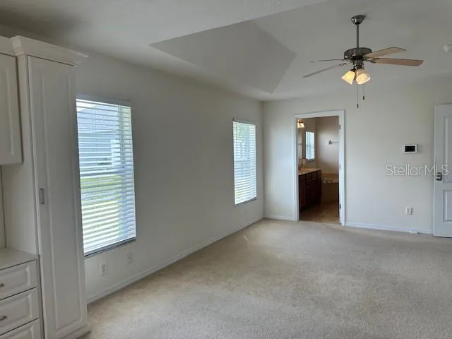 an empty room with windows and closet