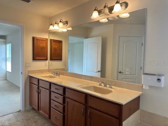 an empty room with a chandelier fan and a chandelier fan