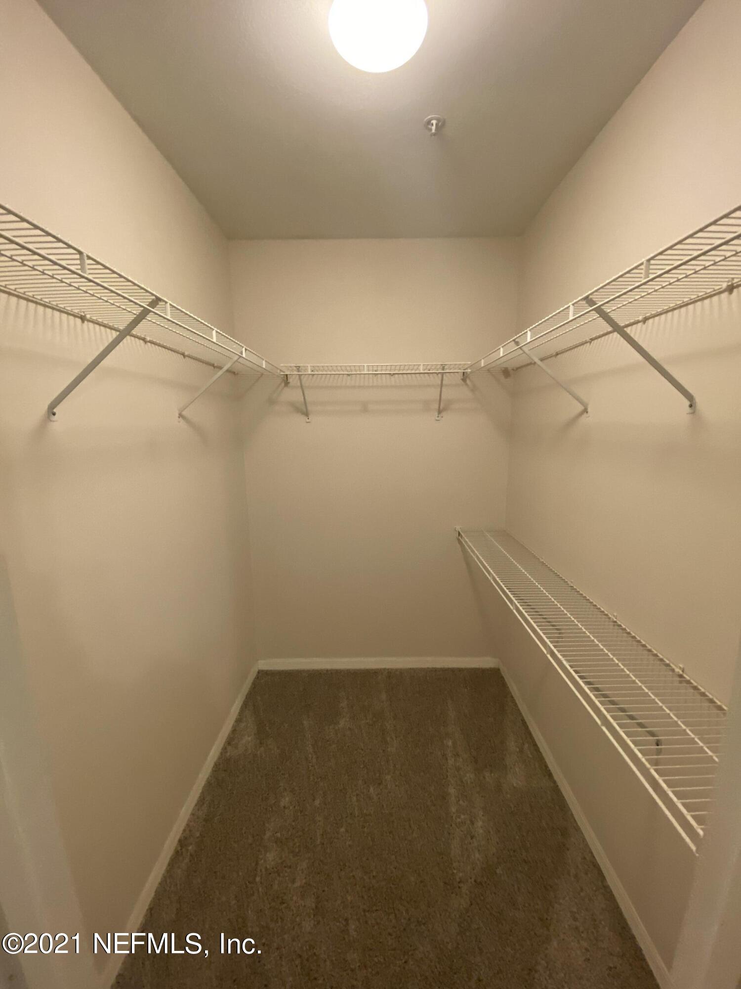 7800 Point Meadows Drive, Unit 422 Jacksonville, FL 32256 - Photo 11 of 38 a view of a room with racks on the wall