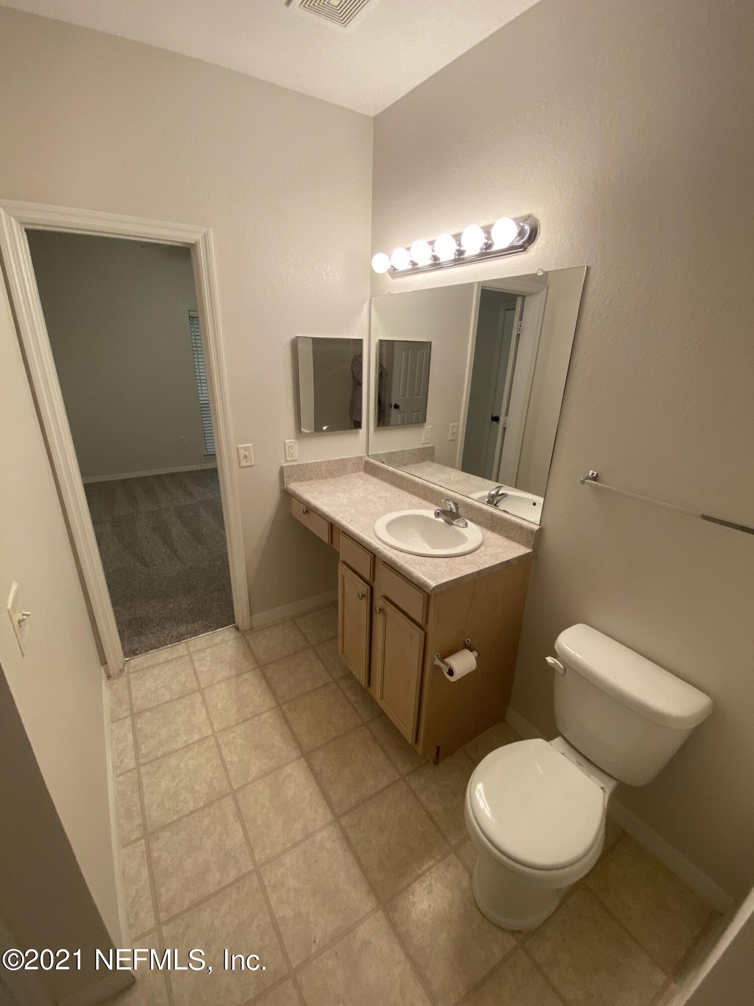 7800 Point Meadows Drive, Unit 422 Jacksonville, FL 32256 - Photo 14 of 38 a bathroom with a sink toilet and mirror
