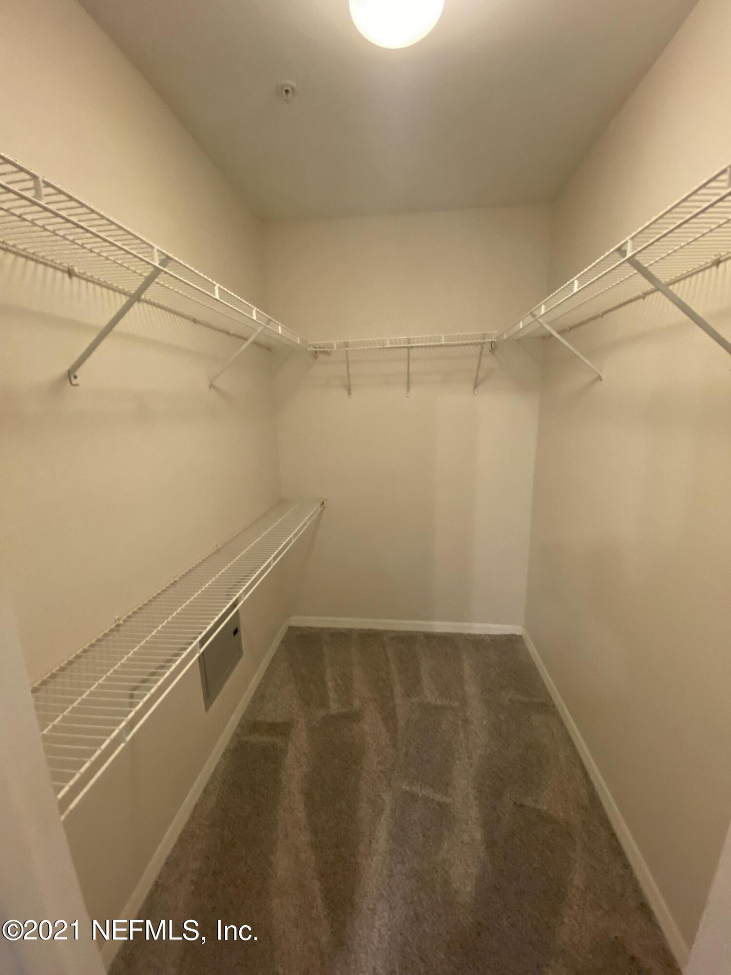 7800 Point Meadows Drive, Unit 422 Jacksonville, FL 32256 - Photo 18 of 38 a view of a room with racks on the wall